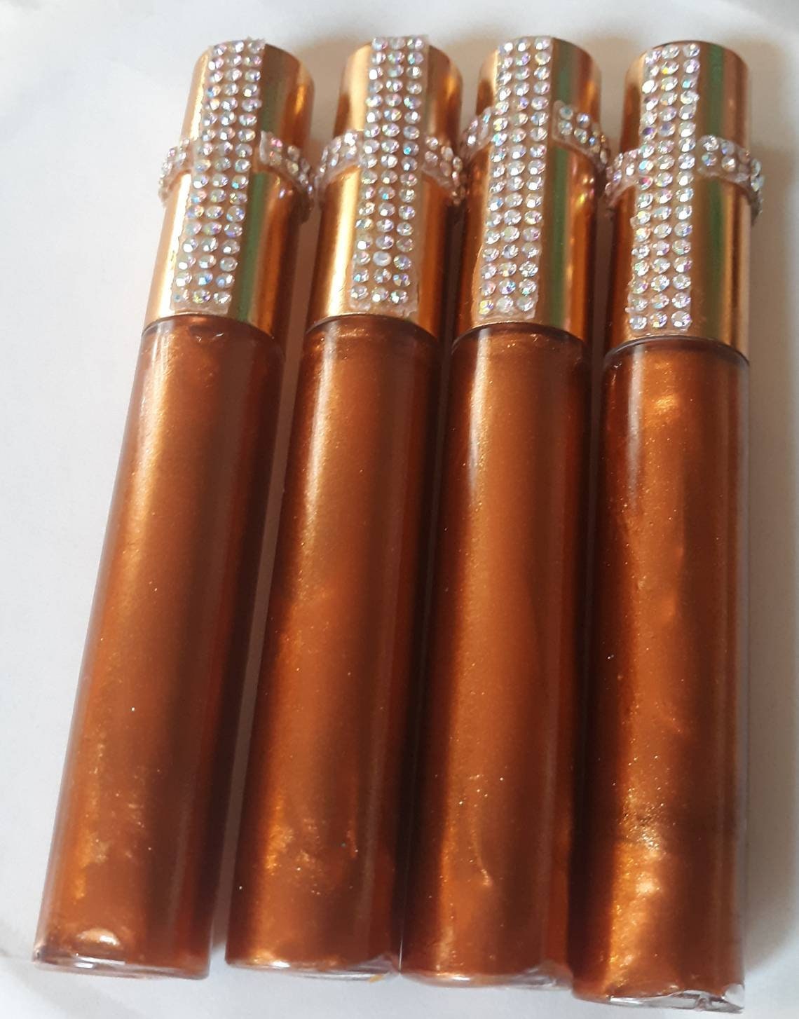 Bronze Beauty- A bronze tinted lip gloss with bronze flecks throughout.